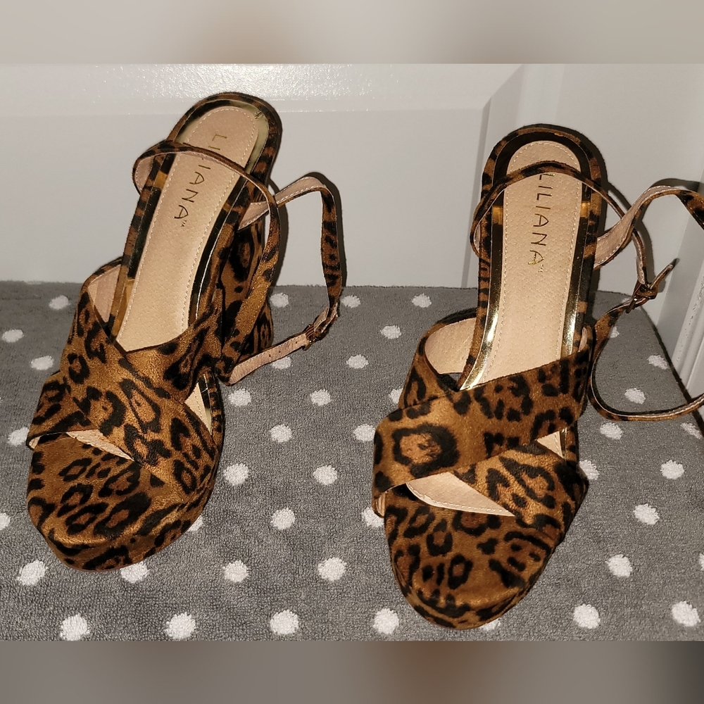 Leopard print platform heels with ankle strap.